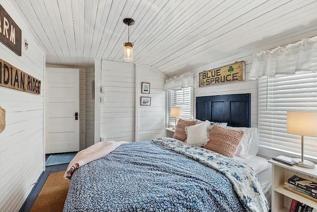 bedroom featuring wooden ceiling, wooden walls, and wood finished floors