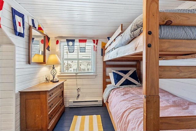 bedroom featuring wood walls, a baseboard radiator, and wood ceiling