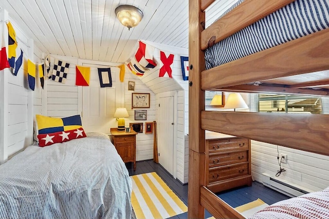 bedroom with a baseboard radiator, wooden ceiling, wood walls, and wood finished floors