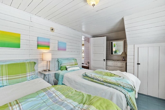 bedroom featuring wood ceiling and wooden walls