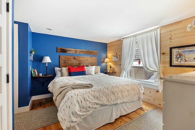 bedroom with baseboards and wood finished floors