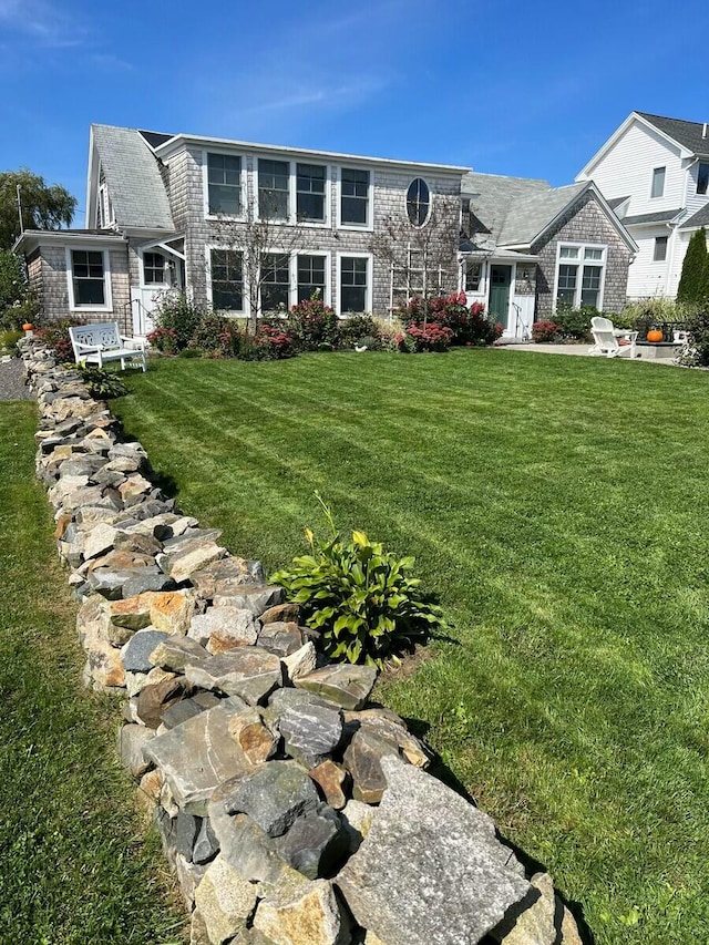 shingle-style home with a front lawn