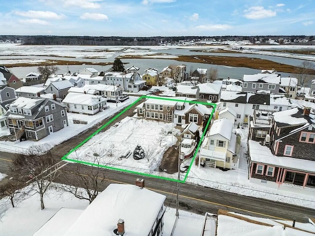 snowy aerial view with a residential view