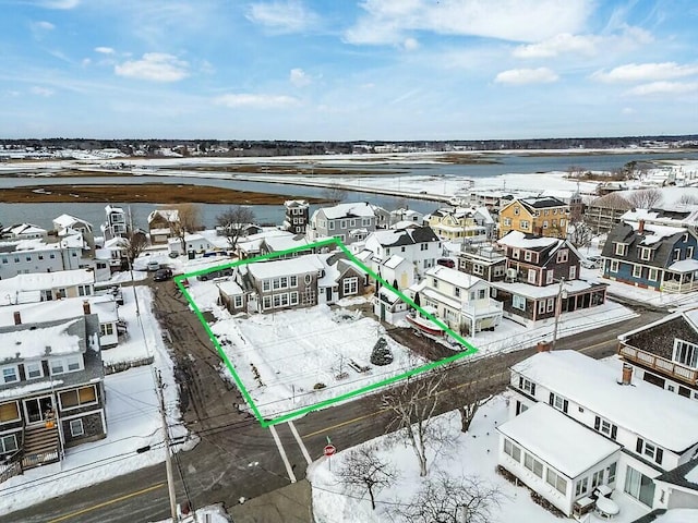 snowy aerial view with a residential view