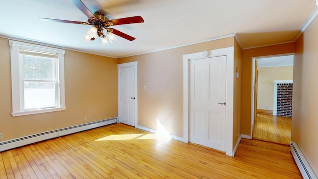 unfurnished bedroom featuring light wood finished floors, baseboards, baseboard heating, and ornamental molding