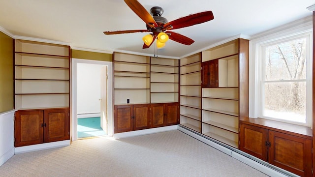 empty room featuring a baseboard heating unit, light colored carpet, a baseboard radiator, and a healthy amount of sunlight