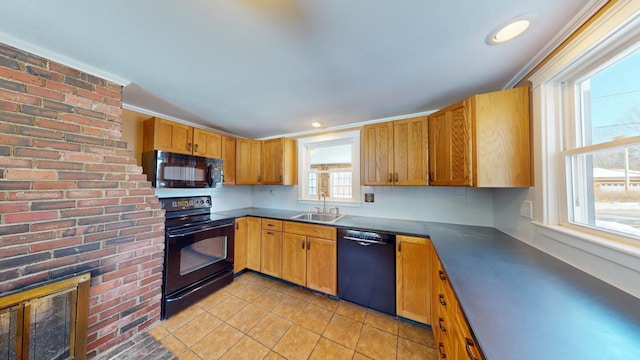 kitchen featuring light tile patterned flooring, black appliances, dark countertops, and a sink