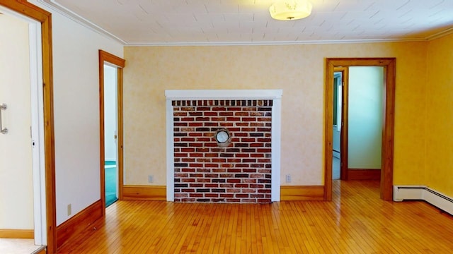 unfurnished room with baseboards, wood-type flooring, baseboard heating, and crown molding