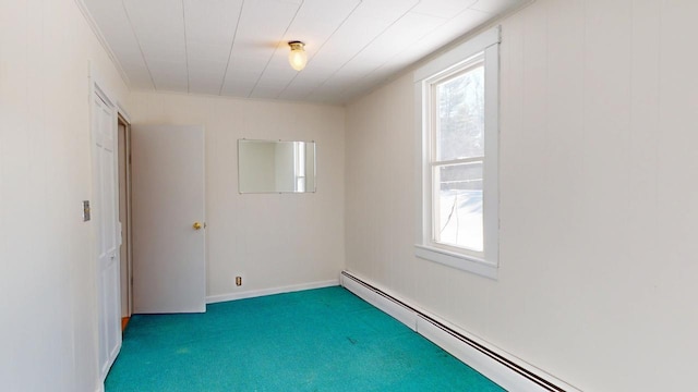 carpeted empty room with a wealth of natural light, a baseboard heating unit, and baseboards