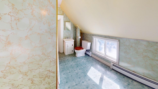 bathroom featuring a sink, lofted ceiling, baseboard heating, and wallpapered walls