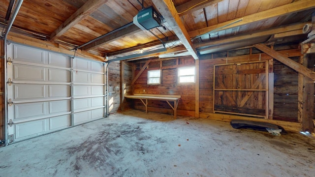 garage with wooden walls and a garage door opener