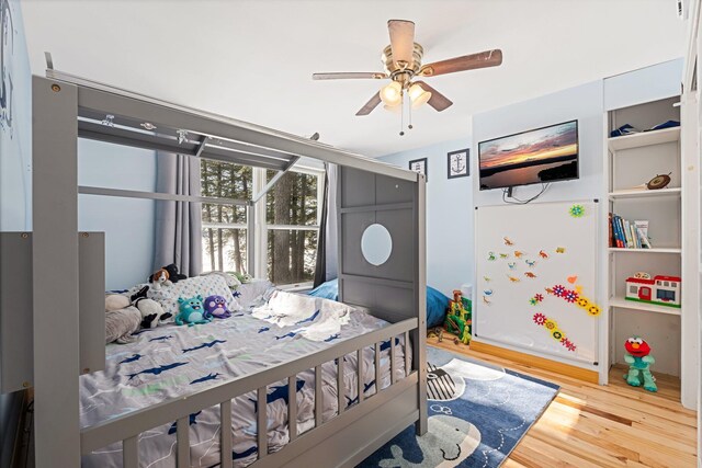 bedroom featuring a ceiling fan and wood finished floors