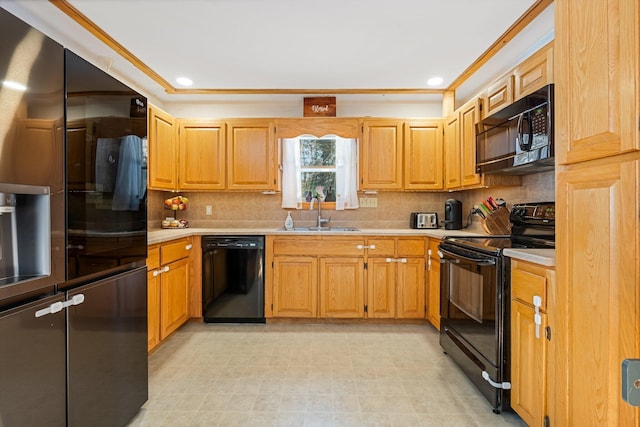 kitchen with a sink, black appliances, backsplash, and light countertops