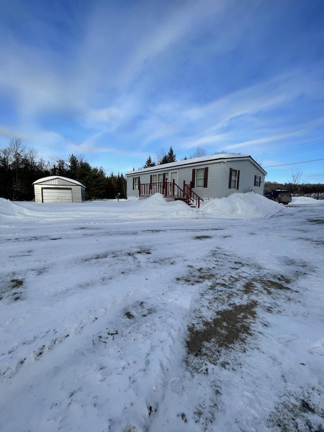 view of front facade featuring a detached garage and an outdoor structure