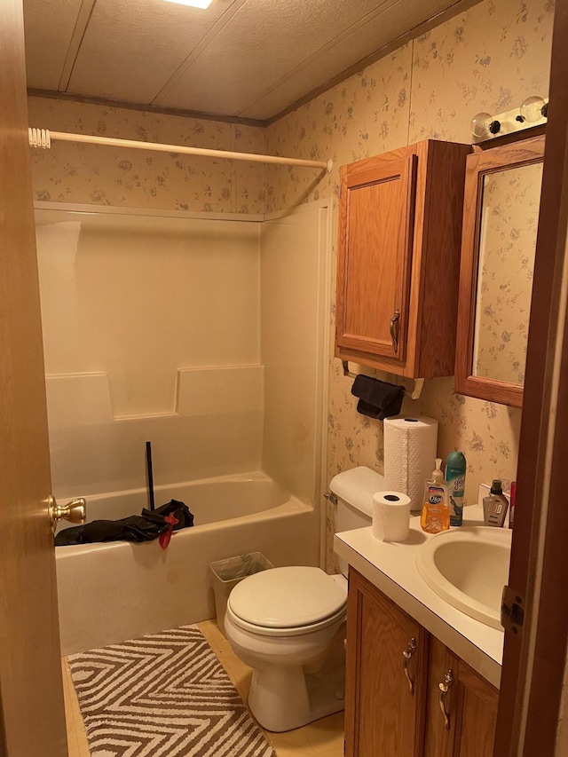 bathroom featuring shower / bathing tub combination, vanity, toilet, and wallpapered walls