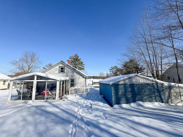 view of snow covered exterior featuring a sunroom