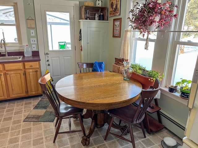 dining area featuring a baseboard radiator and sink