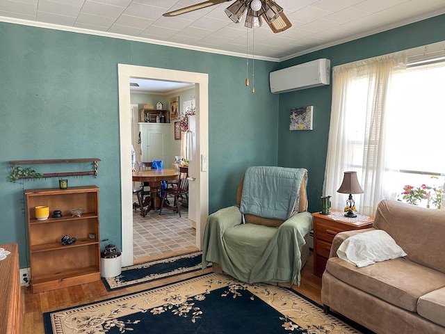 interior space featuring ceiling fan, ornamental molding, wood-type flooring, and a wall mounted AC