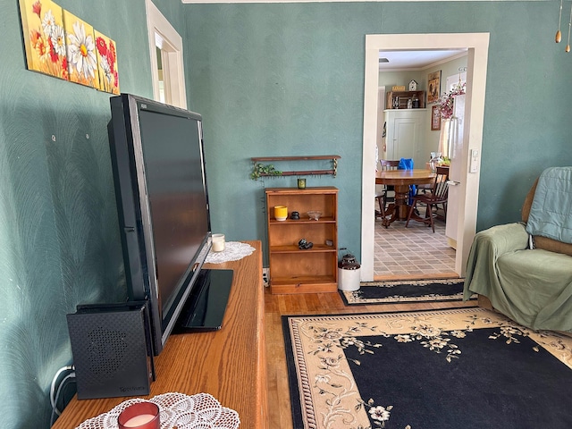 interior space featuring hardwood / wood-style flooring and crown molding