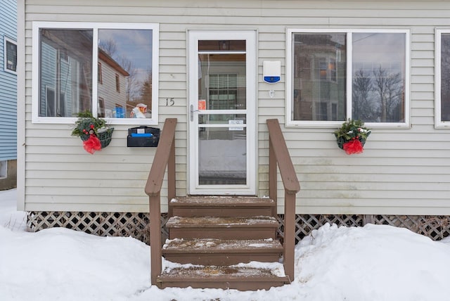 view of snow covered property entrance