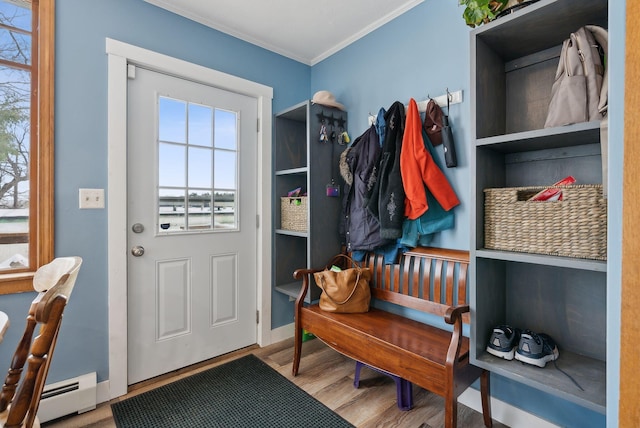 mudroom featuring crown molding, hardwood / wood-style floors, and a baseboard heating unit