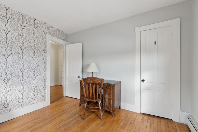 office with a baseboard radiator and light hardwood / wood-style floors