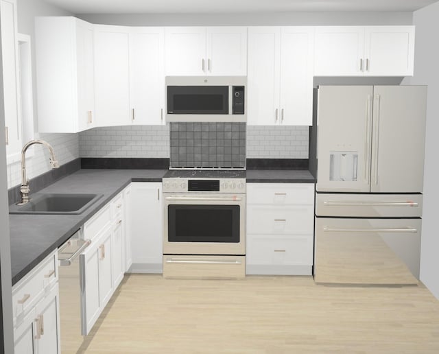 kitchen featuring light wood-style flooring, white appliances, white cabinets, dark countertops, and a sink