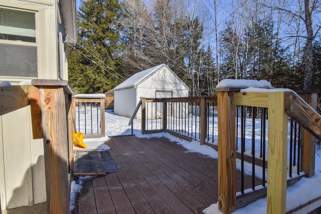 snow covered deck with a shed