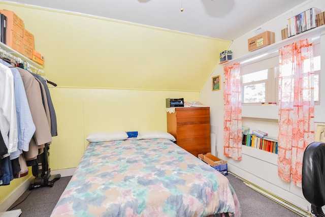 bedroom featuring lofted ceiling, ceiling fan, and carpet