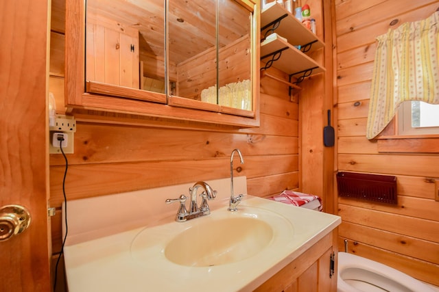 bathroom featuring wood ceiling, vanity, and wood walls