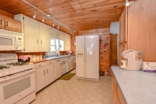 kitchen featuring pendant lighting, wood ceiling, white appliances, and wood walls