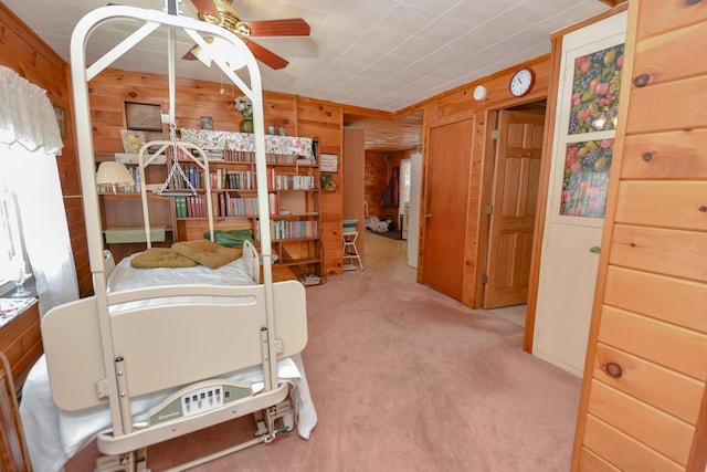 carpeted bedroom featuring wood walls