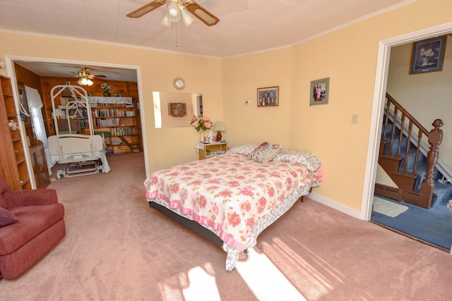 bedroom with crown molding, carpet floors, and ceiling fan