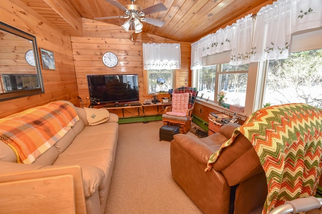 carpeted living room featuring ceiling fan, wood walls, vaulted ceiling, and wooden ceiling