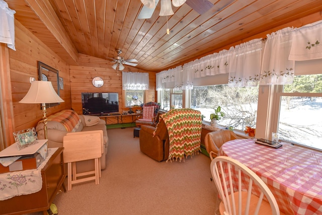 living room featuring wooden walls, lofted ceiling, carpet, wood ceiling, and ceiling fan