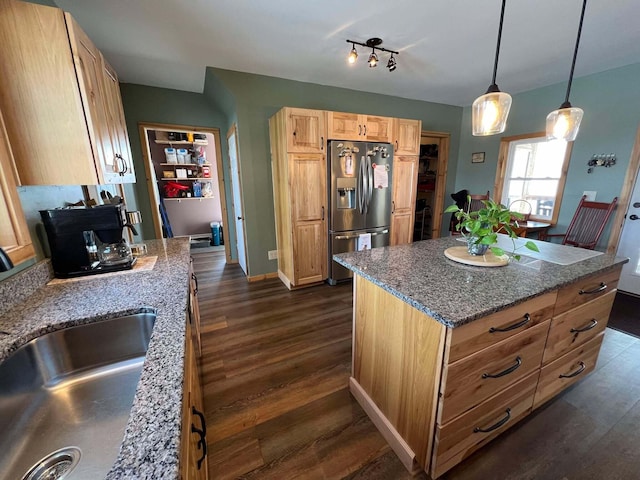 kitchen with a kitchen island, pendant lighting, sink, dark hardwood / wood-style flooring, and stainless steel refrigerator with ice dispenser