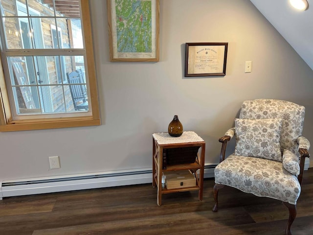 living area with dark hardwood / wood-style flooring, plenty of natural light, lofted ceiling, and baseboard heating