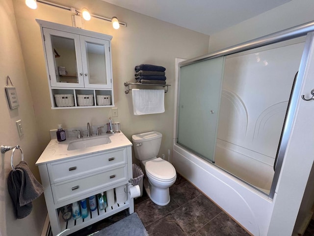 full bathroom with toilet, vanity, and bath / shower combo with glass door