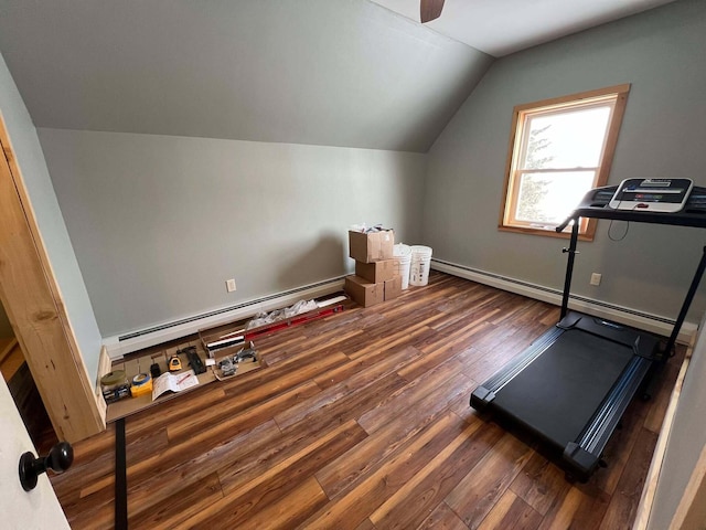 workout area with dark wood-type flooring, vaulted ceiling, and baseboard heating