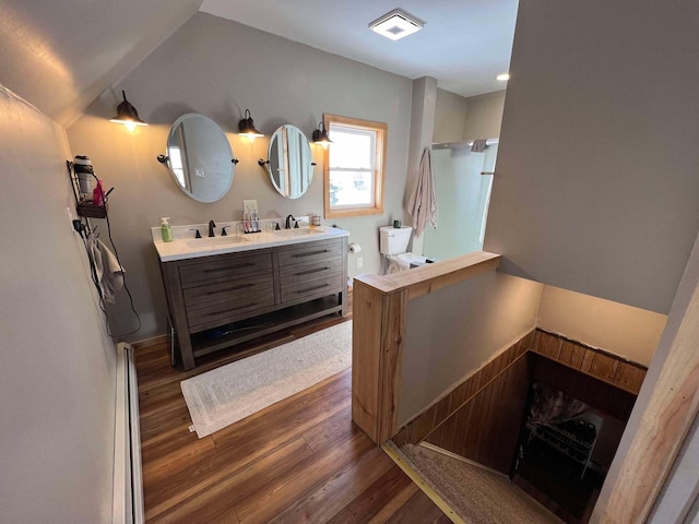 bathroom featuring toilet, a shower, vaulted ceiling, vanity, and hardwood / wood-style flooring