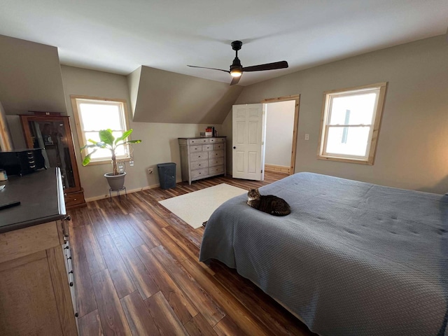 bedroom with vaulted ceiling, dark hardwood / wood-style floors, and ceiling fan