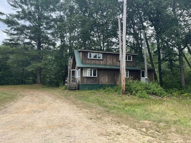 83 River Rd, Hiram, ME 04041 - view of front facade with a metal roof and a chimney