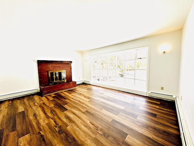 unfurnished living room with a baseboard heating unit, baseboard heating, wood finished floors, and a fireplace