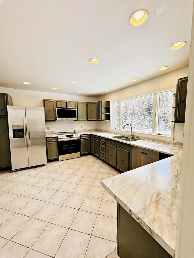 kitchen featuring recessed lighting, stainless steel appliances, and a sink