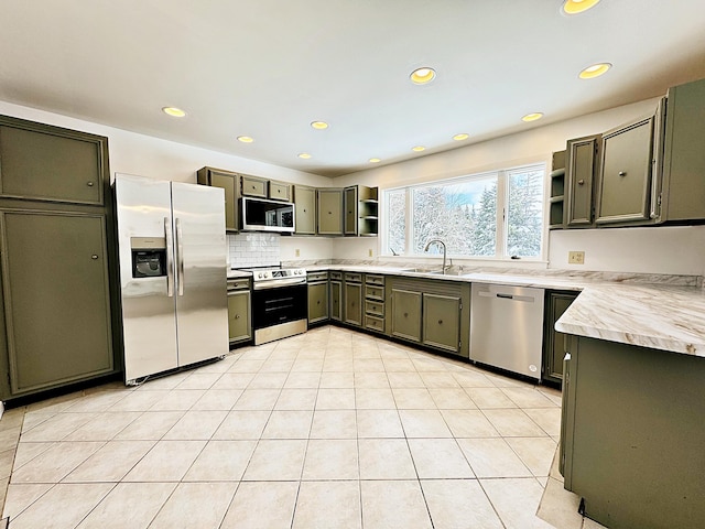 kitchen with open shelves, light countertops, backsplash, a sink, and appliances with stainless steel finishes
