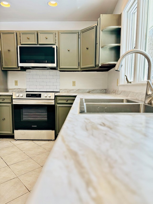 kitchen featuring a sink, recessed lighting, appliances with stainless steel finishes, light countertops, and light tile patterned floors