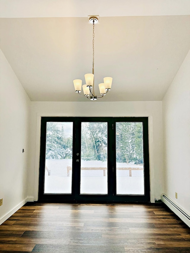 interior space featuring a baseboard heating unit, vaulted ceiling, a notable chandelier, and wood finished floors
