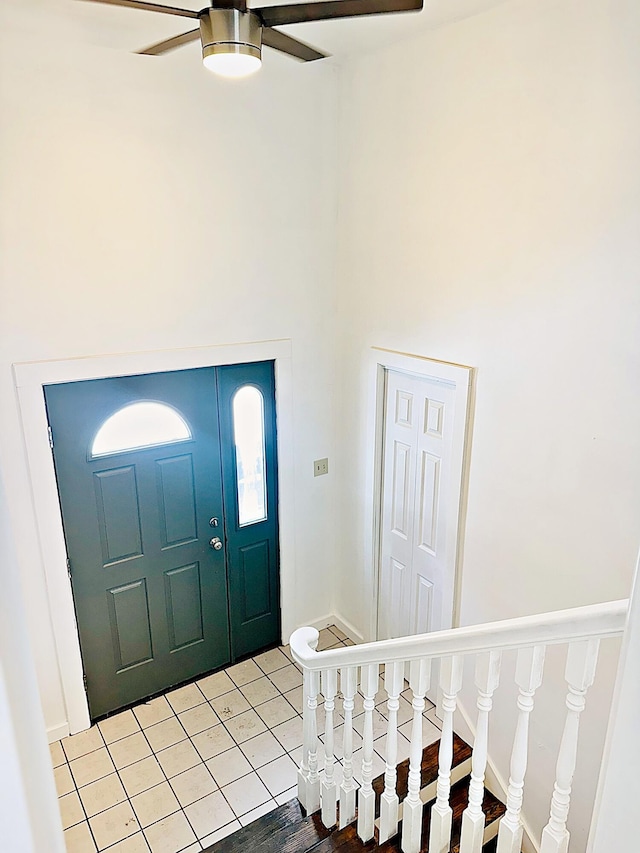 foyer entrance featuring ceiling fan, a high ceiling, and light wood-type flooring