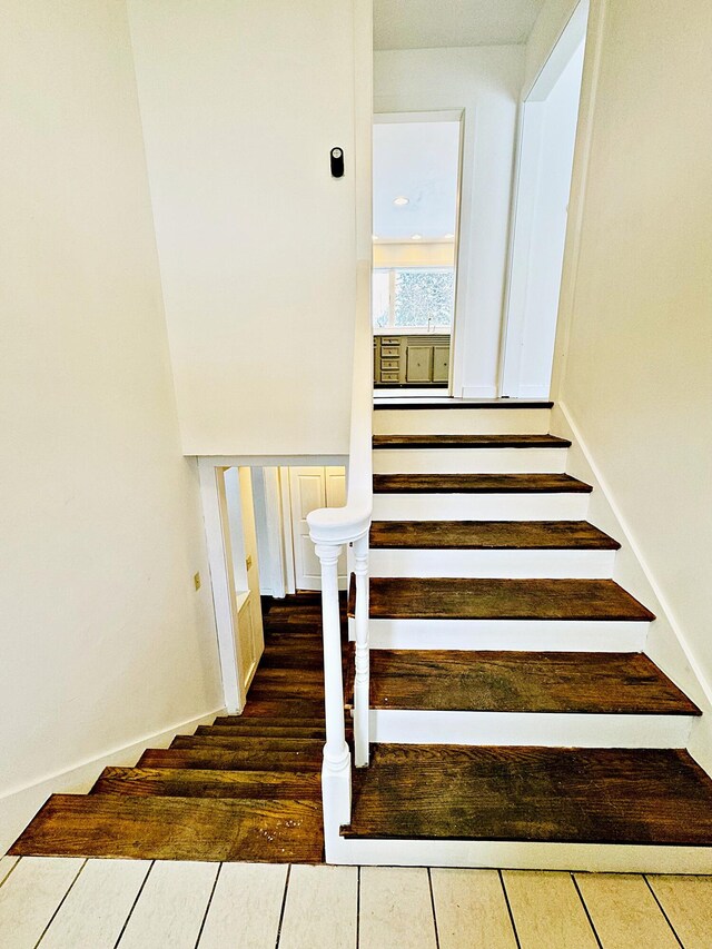 stairs with wood finished floors
