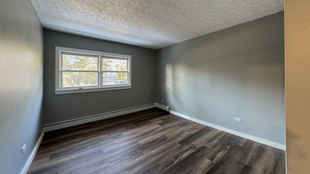 unfurnished room with baseboard heating, baseboards, a textured ceiling, and dark wood finished floors
